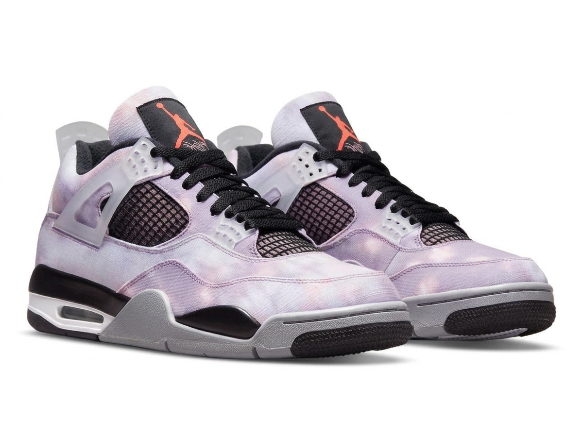 Air Jordan 4 sneaker in washed lilac canvas with black laces and orange Jumpman logo, angled pair view
