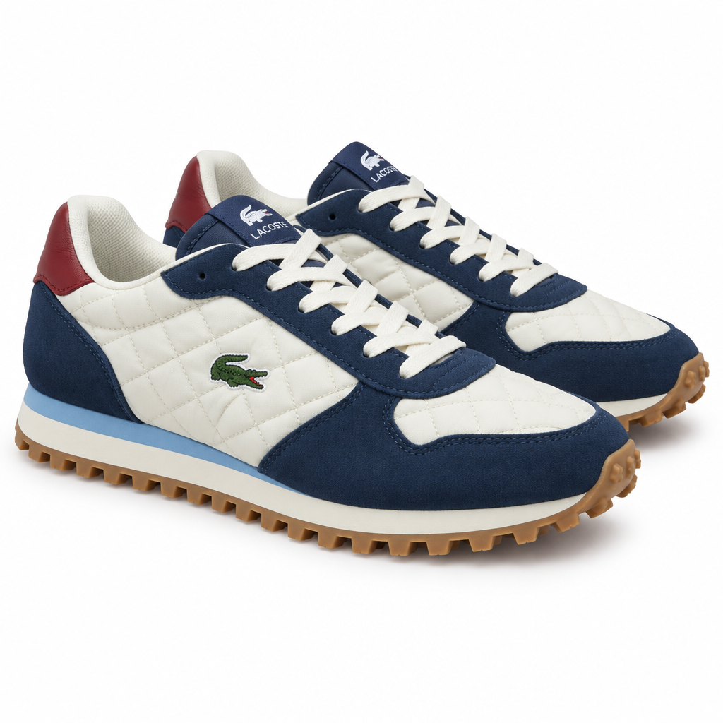 Navy and cream quilted sneakers with burgundy heel and gum trail sole on a plain white background