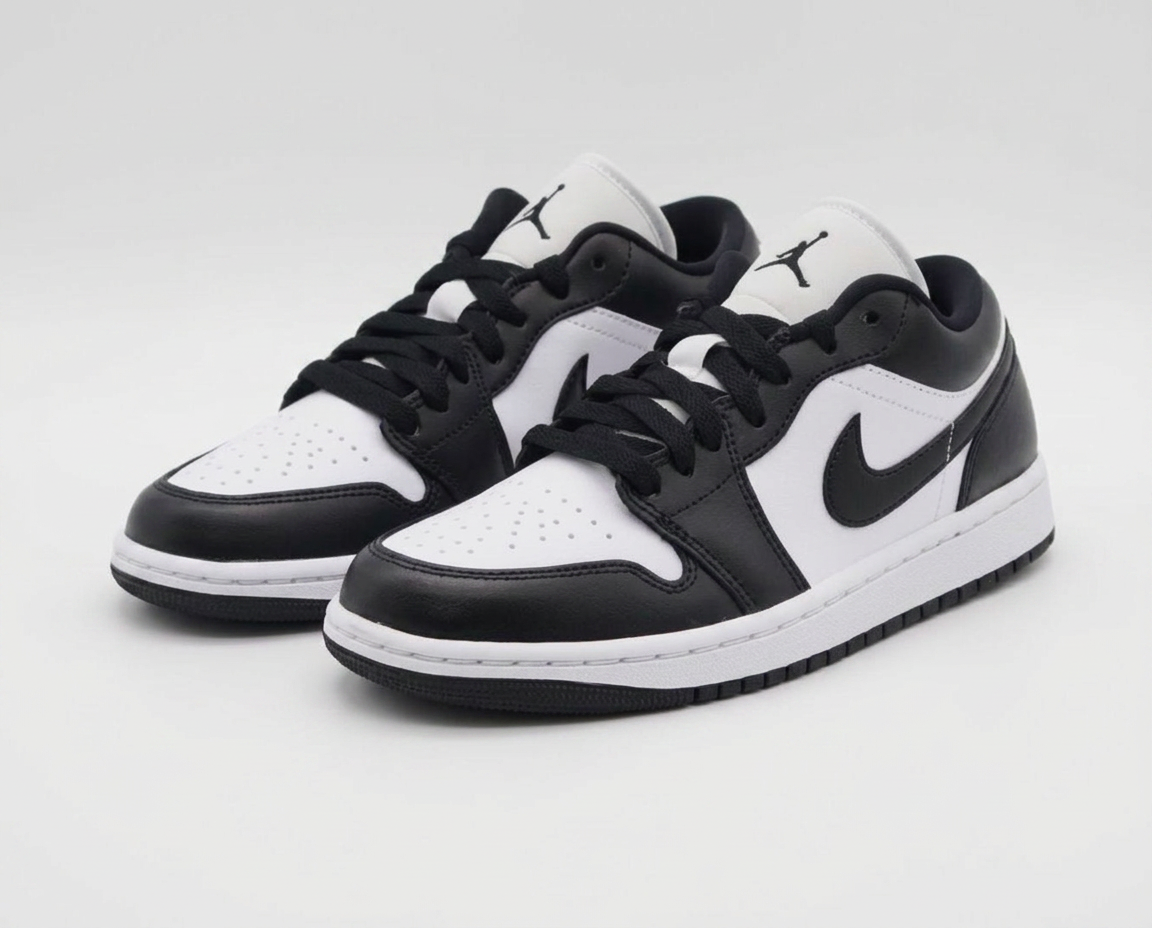 Black and white Air Jordan 1 Low panda sneakers on a plain white background