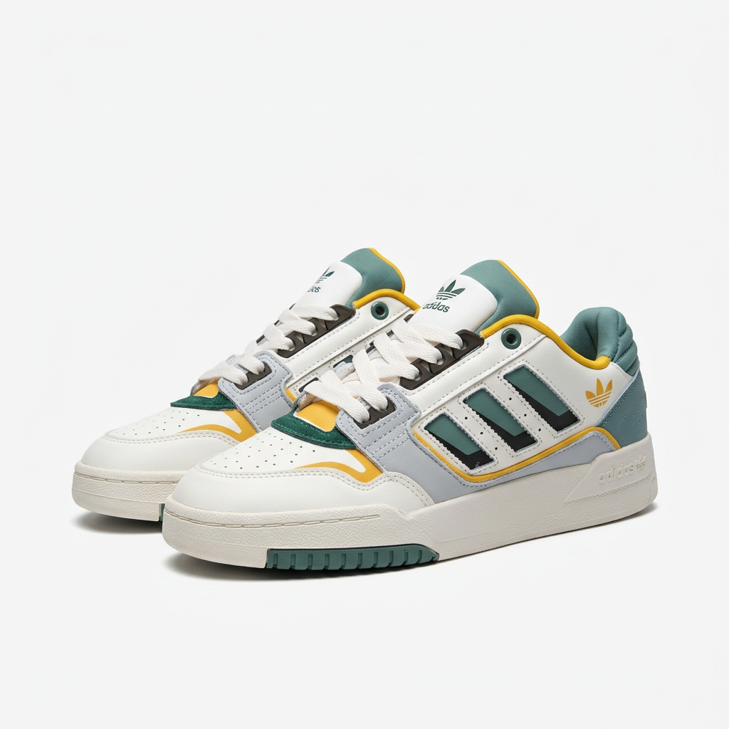 Pair of white adidas Forum Low sneakers with green stripes and gold trim on white