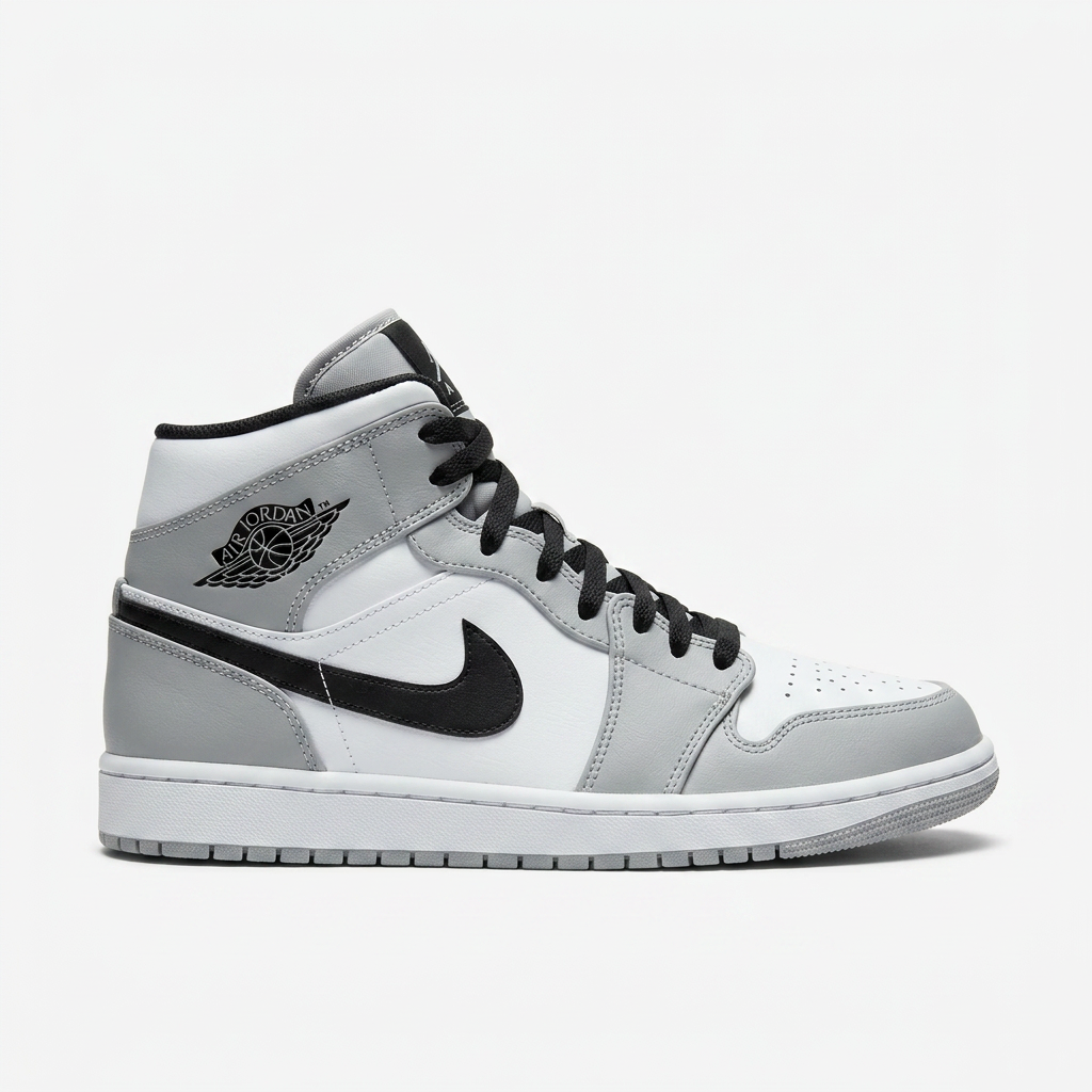 Air Jordan 1 Mid in light smoke grey and white leather with black Swoosh, worn on street