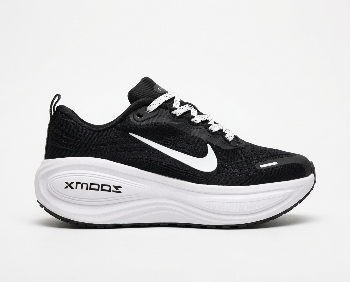 Black mesh running sneaker with white swoosh and tall white cushioned midsole on a plain white background