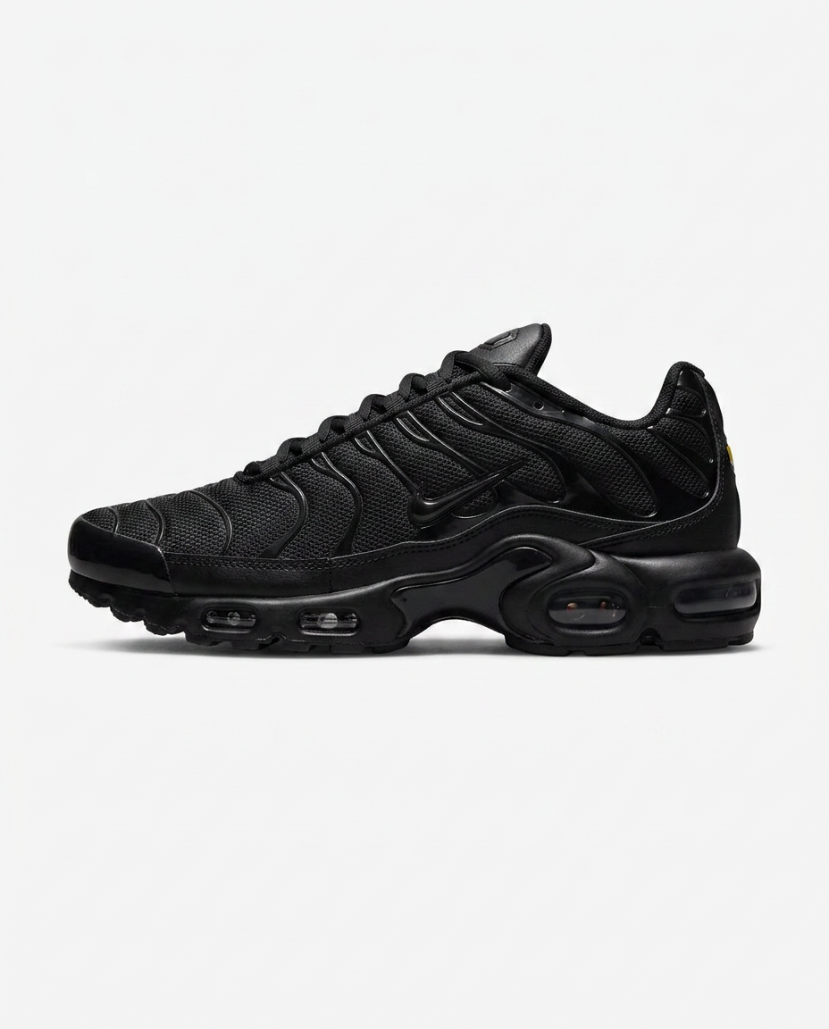 Blacked-out Air Max Plus with tuned air in the heel on a plain white background